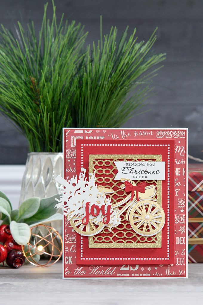 Spellbinders | Layered Dimensional Die Cutting. Episode #4 – Christmas Bicycle Card by Yana Smakula using S2-266 Ho Ho Ho, S3-272 Build a Stocking, S3-282 Bicycle, S4-793 Gossamer Knot Ensemble, S4-822 Deck the Halls, S5-308 Hemstitch Rectangles Dies #spellbinders #diecutting #christmascard #handmadecard