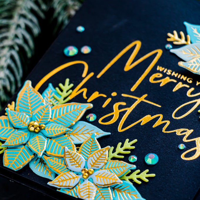 Spellbinders | Foiled Merry Christmas card by Yana Smakula featuring GLP-204 Stylish Script Merry Christmas and GLP-196 Glimmer Poinsettia Glimmer Hot Foil #Spellbinders #NeverStopMaking #Christmascard #GlimmerHotFoilSystem