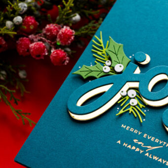 Another creative use was framing a sentiment with multiple “Joy” die-cuts in the corners — a completely different layout that draws the eye to the message at the center. (Side note: you may spot a missing “E” in my example — that was a prototype! Your finished dies will have everything you need.)